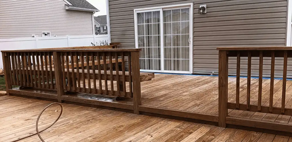 Deck sealing service protecting a backyard wood deck and railings in St Paul, MN