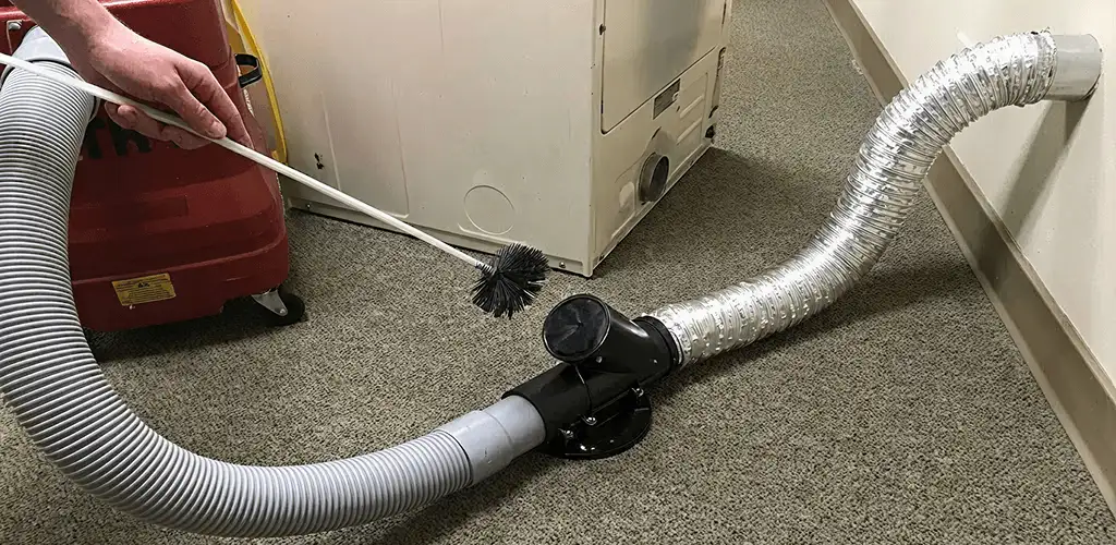 Dryer vent cleaning service removing lint from a dryer duct connection in St Paul, MN