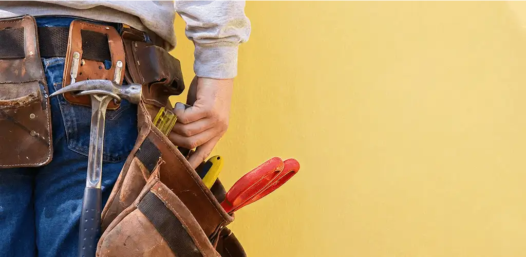 Handyman with tool belt ready for home repairs and maintenance in St Paul, MN
