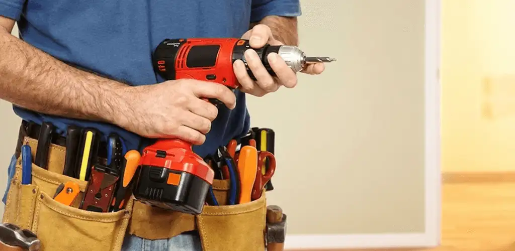 Handyman holding a power drill for home repairs and installations in St Paul, MN