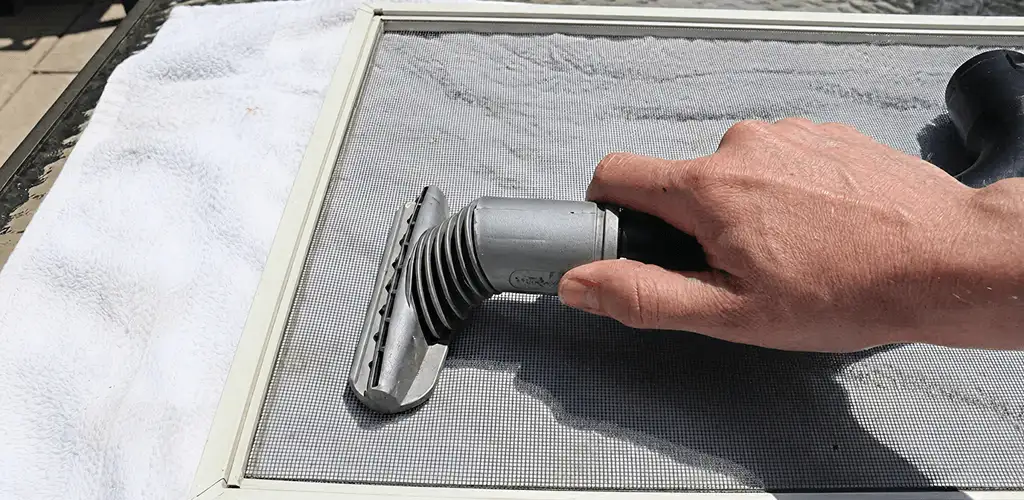 Window screen repair cleaning and fixing a damaged screen mesh in St Paul, MN